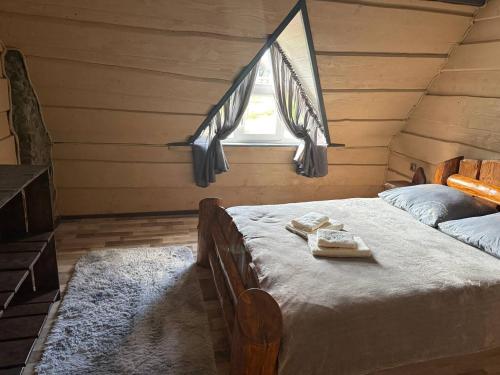 a bedroom with a bed with towels on it at Горянка in Oryava