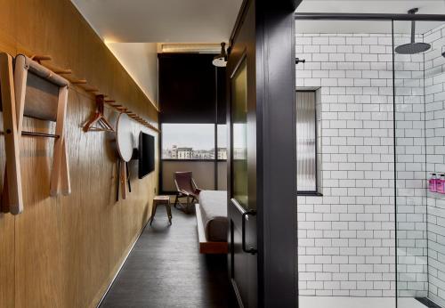a hallway with a table and chairs in a room at MOXY Minneapolis Uptown in Minneapolis