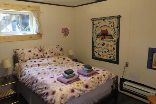 a bedroom with a bed with books on it at Friendly Footprint in Golden