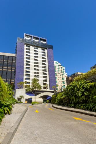a tall building with a road in front of it at Intercity Faria Lima Address in São Paulo