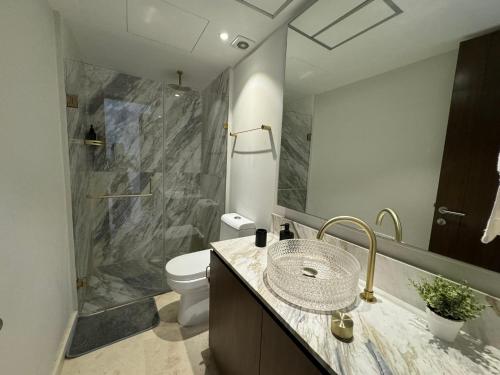 a bathroom with a sink and a toilet and a shower at Departamento Diamante Azul Punta Mita, Beach Front in Punta Mita