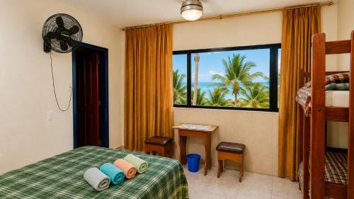 a bedroom with a bed with a view of the ocean at La Casa Ucraniana in Canoa