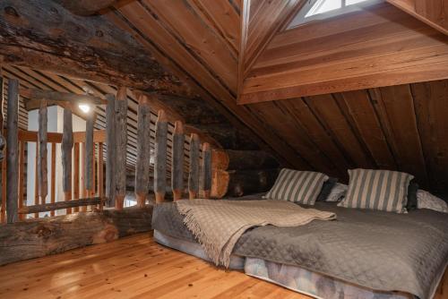 a bed in a room with a wooden ceiling at Holiday Home Ruka Etelärinne 10 B in Ruka