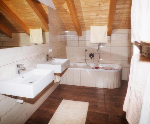 a bathroom with two sinks and a bath tub at Niederhof in Parcines