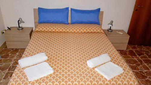 a bedroom with a large bed with blue pillows at La casa di Lori in San Benedetto del Tronto