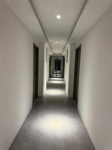 an empty corridor in an office building with white walls at Whalesharkview in Maamigili