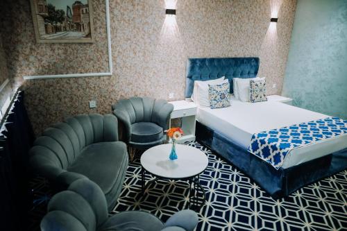 a hotel room with a bed and a chair at Avenue Nizami hotel in Baku