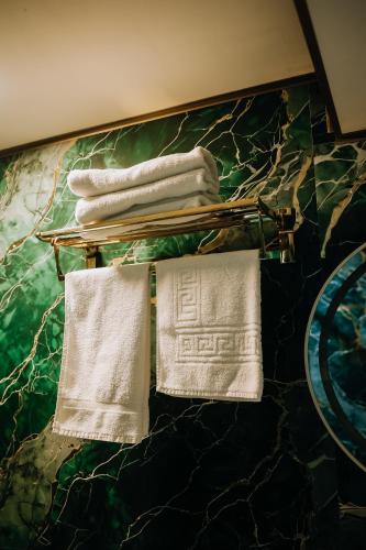 two white towels are hanging on a counter at Avenue Nizami hotel in Baku