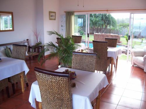 a restaurant with tables and chairs in a room at Anchorage B&B in Elysium