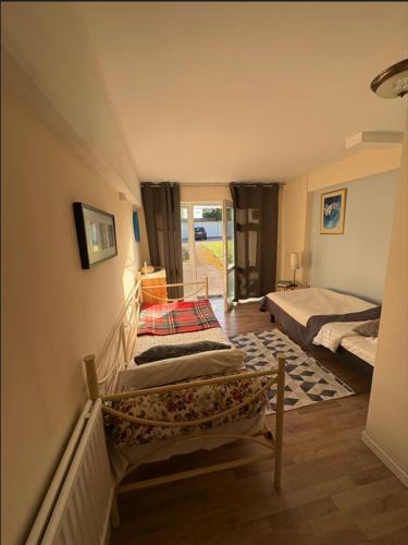 a room with two beds and a staircase with a door at The Old Garages in Uddeholm