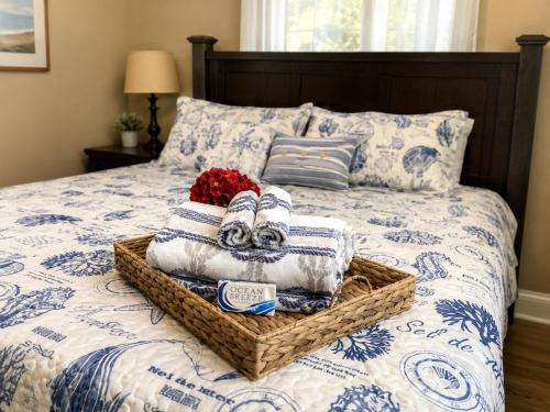 a bed with a basket of towels on it at Tropical Oasis 10th in Bradenton