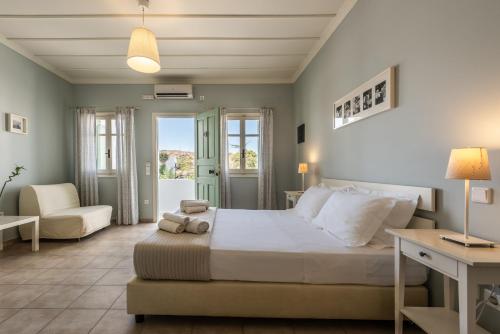 a bedroom with a bed and a chair and a desk at Almyris in Adamantas