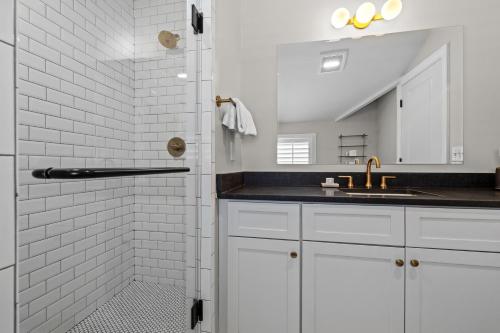 a white bathroom with a sink and a shower at The Germantown Inn in Nashville