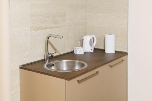 a kitchen counter with a sink in a room at B&B Alba in Celano