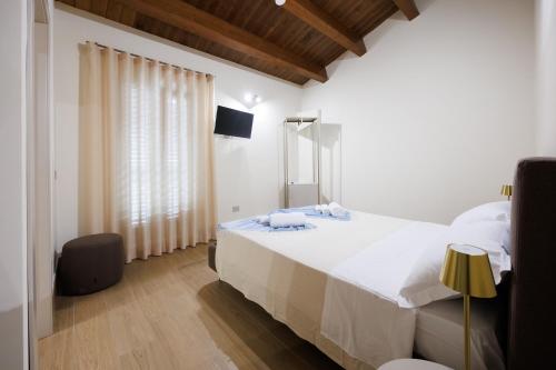 a bedroom with a large white bed and a window at B&B Alba in Celano