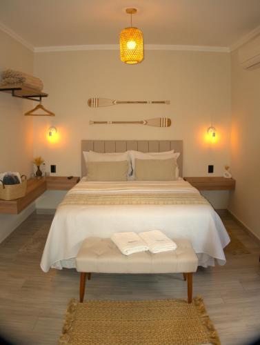 a bedroom with a large bed with two towels on it at Angatu Chalés in Serra Negra
