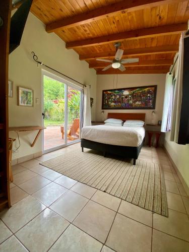 a bedroom with a bed and a ceiling fan at Lake Front Retreat at Los Elementos in Santa Cruz La Laguna