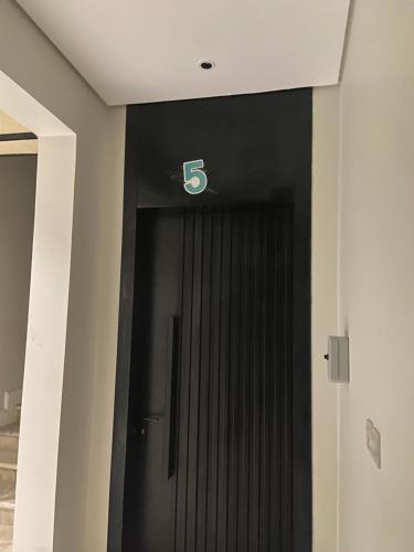a black door with a letter b on it at الضاحية 