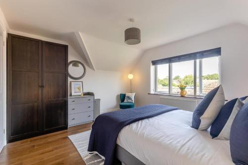a bedroom with a large bed and a window at 5 Bed in Bodham oc-2204 in Bodham
