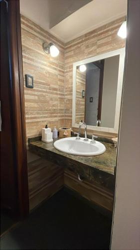 a bathroom with a sink and a mirror at aromasdelpandeazucar in Unquillo
