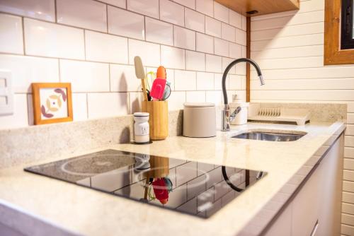 a kitchen with a sink and a counter top at Morada dos Butiás in Imbituba