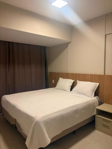 a bedroom with a large bed with white sheets and pillows at View Soft House - Quarto e Sala 213 in Lauro de Freitas