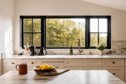 a kitchen with a bowl of fruit on a table at Onyx Ridge Breathtaking Views 14 Acres in Jeffersonville