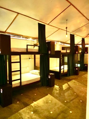 a group of bunk beds in a room at Way of The Bay in Arugam Bay