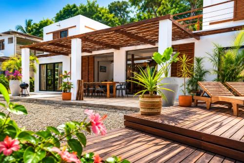 a patio of a house with a wooden deck at Casa La Rayanna in Palomino