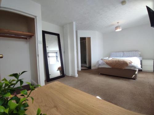 a living room with a bed and a mirror at Central Stay Blackpool in Blackpool