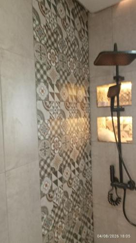 a bathroom with a wall with a patterned wall at Chalet Dar Well-Ness in Dar Mohammed Salah