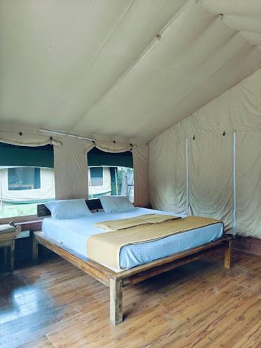 a bedroom with a bed in a tent at LIVAA NEST Resort Mysore in Kālvādi