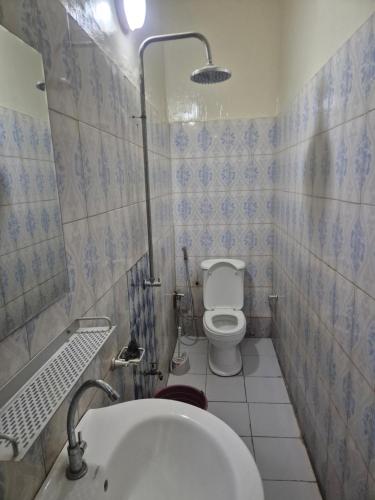 a small bathroom with a toilet and a sink at SEN-HOME Free in Dakar