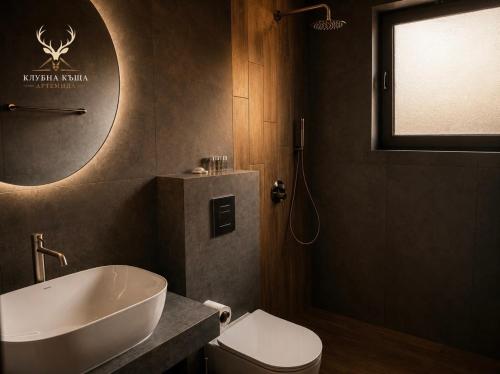 a bathroom with a white sink and a toilet at Клубна къща Артемида - Стая in Pravets
