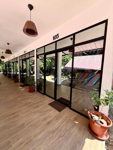 an empty building with glass doors and potted plants at Chaikoni Lodge in Pucallpa