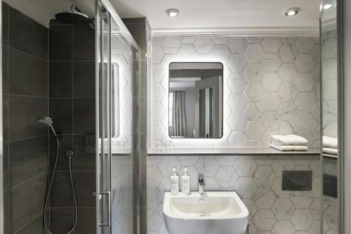 a bathroom with a shower and a sink and a mirror at Four Points Flex by Sheraton Nottingham in Nottingham