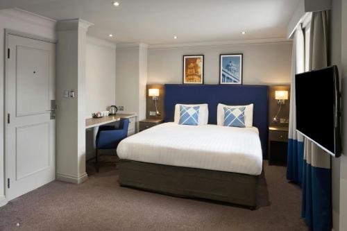 a bedroom with a bed and a desk and a television at Four Points Flex by Sheraton Nottingham in Nottingham