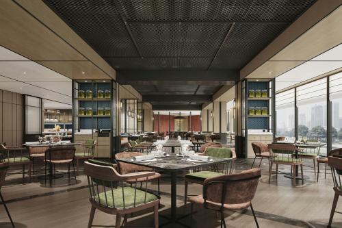 a restaurant with tables and chairs and windows at Four Points by Sheraton Guilin Central in Guilin