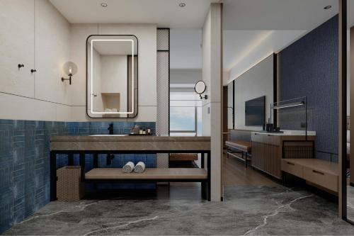 a bathroom with a sink and a mirror at Four Points by Sheraton Fuzhou Changle in Fuzhou