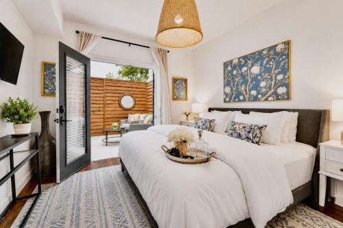 a bedroom with a large bed and a living room at Chic Dallas Retreat Trail, Soaking Tub & Patio in Dallas
