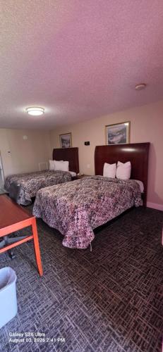 a hotel room with two beds in a room at Red Carpet Inn Williamstown in Williamstown