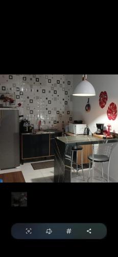 a kitchen with a table and chairs in it at Ertal House in Blumenau