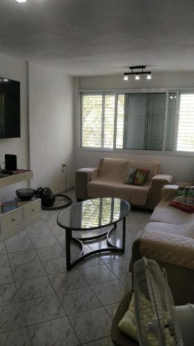 a living room with a couch and a table at דירת 80 מ"ר למשפחה או זוג in Qiryat Bialik
