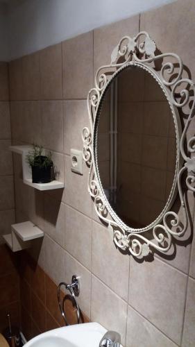 a bathroom with a mirror on a tiled wall at Casa do Alto in Penacova