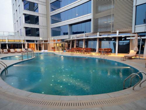 a large swimming pool in the middle of a building at Novotel Jazan in Jazan
