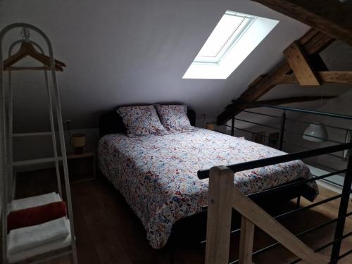 a bedroom with a bed and a ladder at Le Logis de Meung Sur Loire in Meung-sur-Loire