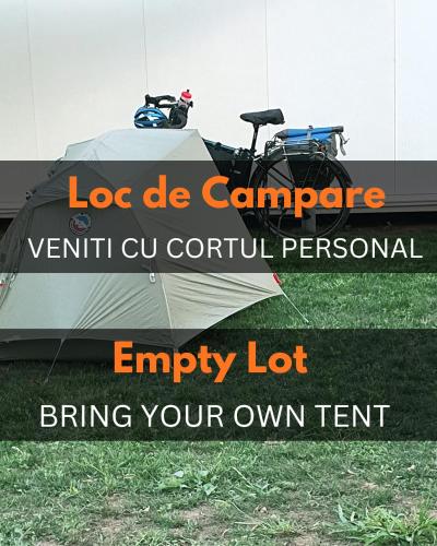 a tent with a motorcycle parked in the grass at Free People Camping in Vama Veche