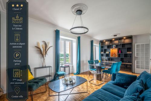 a living room with a blue couch and a table at Le Versailles Suite classé 3 étoiles Vue Château & Potager in Versailles