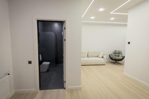 a white living room with a white couch in a room at Lchak Hotel in Yeghegnadzor