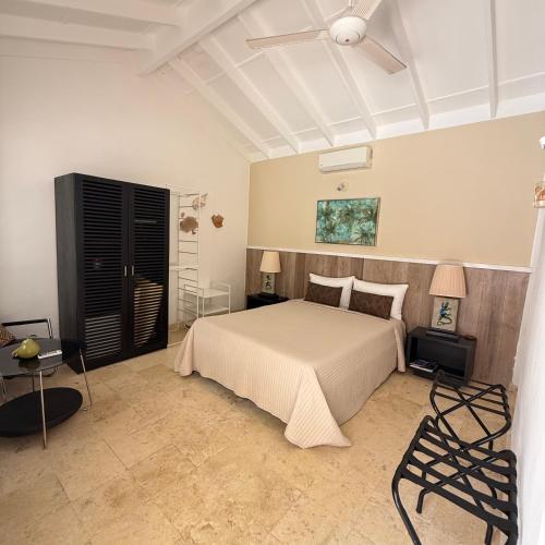 a bedroom with a bed and a ceiling fan at Terra Taina Boutique Bed&Breakfast in Las Terrenas